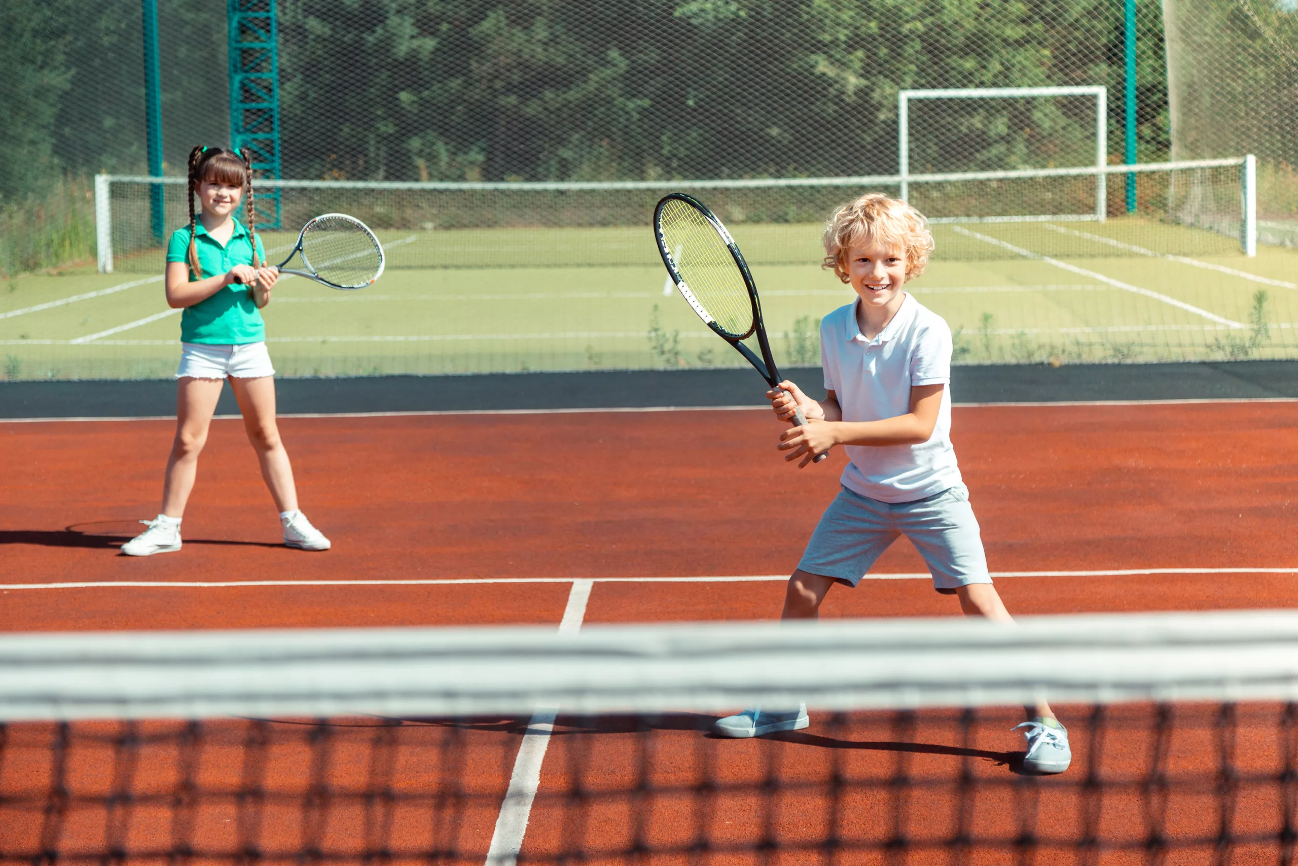 Boy playing Tennis on outdoor courts at Bolton Arena